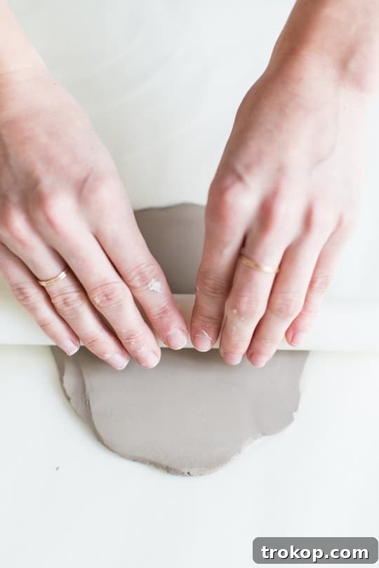 Craft Your Own Kitty Keepsake Dish 5 Rolling out air dry clay to a consistent thickness for crafting