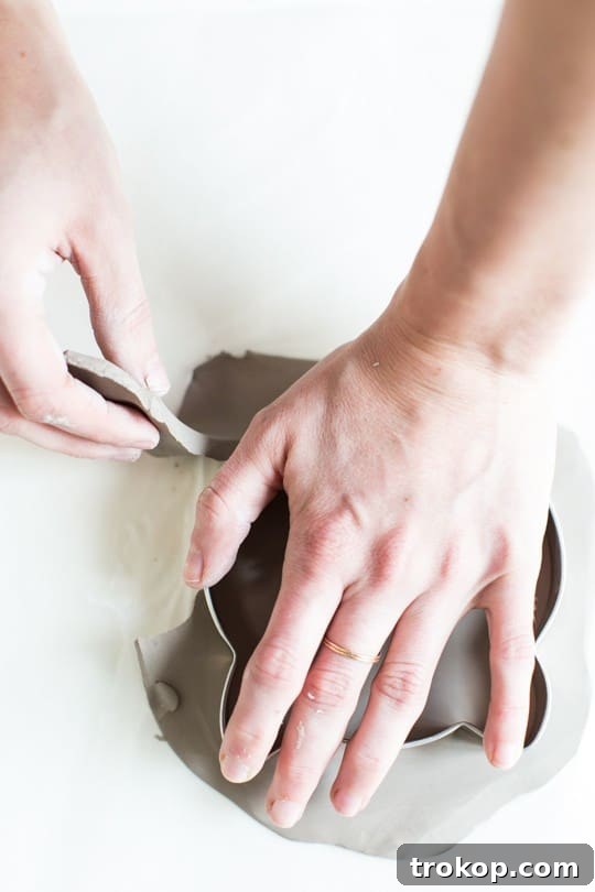 Craft Your Own Kitty Keepsake Dish 6 Using a cat cookie cutter to cut shapes from rolled-out air dry clay