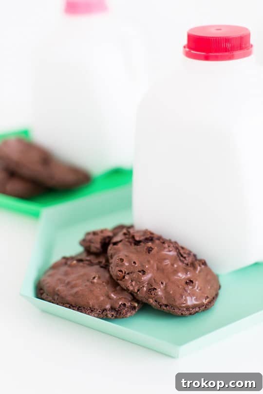 DIY milk and cookie party favors arranged on a tray