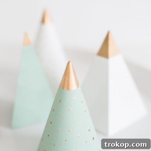 Close up photo of wooden cones painted as Christmas trees