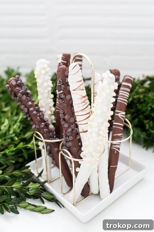 Repurposed condiment holder creatively displaying chocolate-dipped pretzel rods.