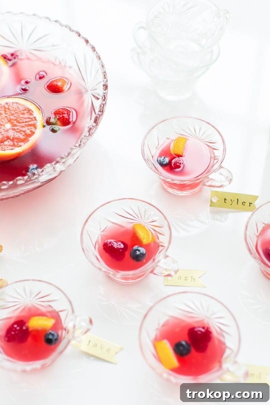 Berry Punch Perfection DIY Brass Drink Markers 4 A beautifully set table with a punch bowl filled with Mixed Berry Punch, surrounded by glasses adorned with brass drink tags, ready for guests.