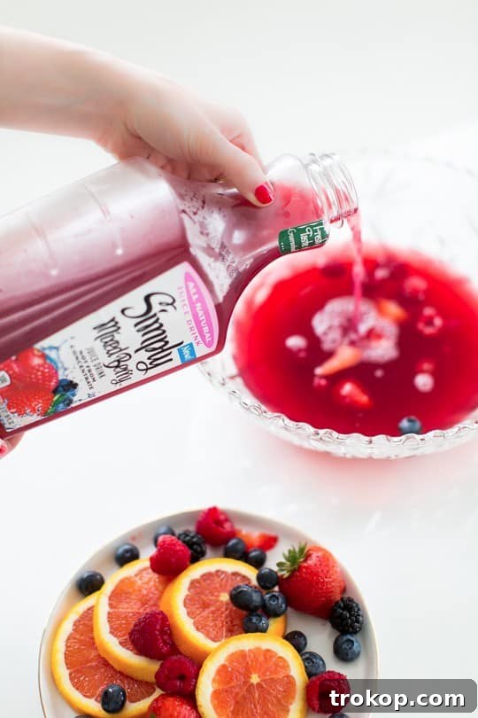 Berry Punch Perfection DIY Brass Drink Markers 6 Ingredients for Mixed Berry Punch laid out, including a bottle of Simply Mixed Berry Juice, Prosecco, and fresh berries.