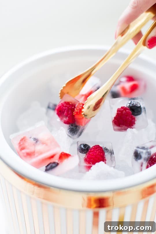 Berry Punch Perfection DIY Brass Drink Markers 8 A hand pouring sparkling wine into a punch bowl already containing Simply Mixed Berry Juice, demonstrating the punch mixing process.
