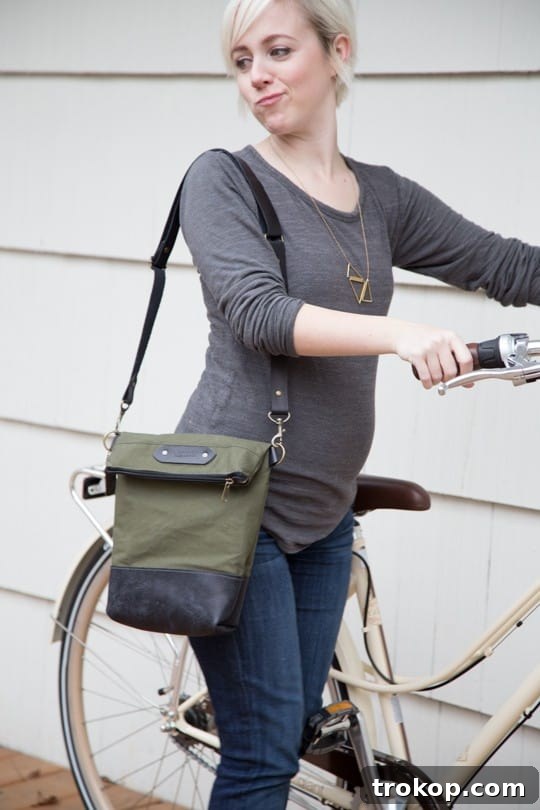 Pregnant Cara enthusiastically modeling a handbag for a giveaway