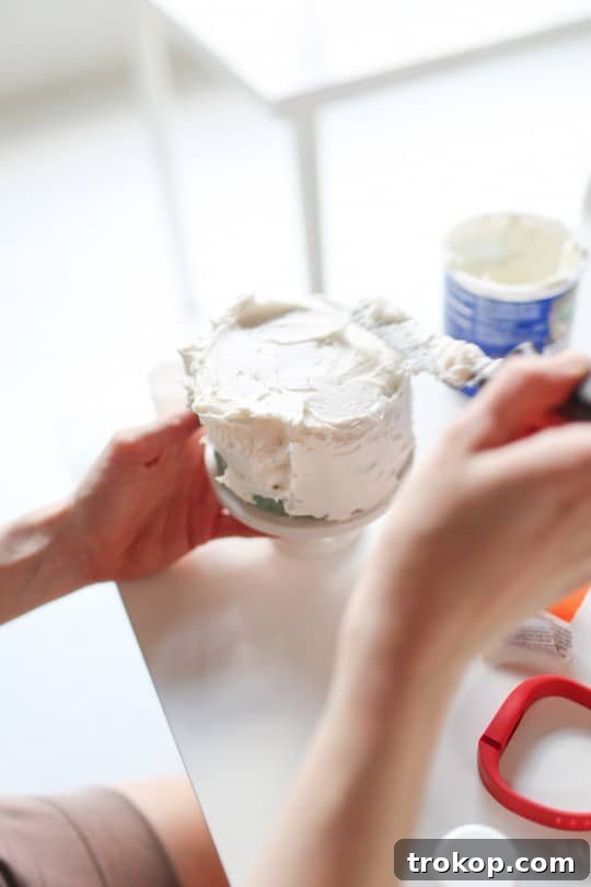 Styrofoam cake being decorated with edible confetti for a photoshoot