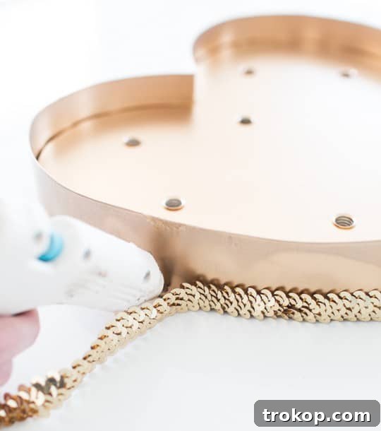 DIY Sparkling Heart Marquee 6 Gluing sequin trim to the marquee heart