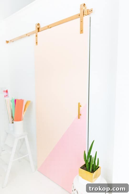 Barn door track installation with a ladder, emphasizing precision.
