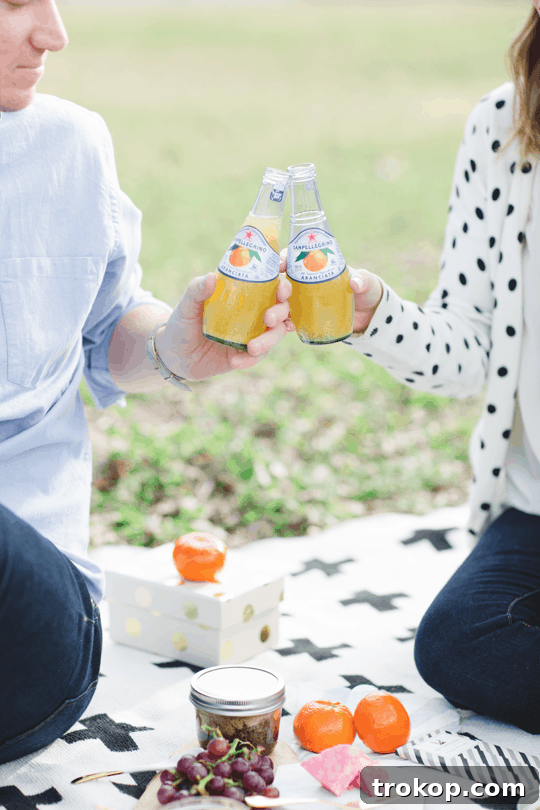 Daytime Adventures for Two 12 Close-up of hands reaching for treats on the picnic blanket, symbolizing shared joy and simple pleasures.