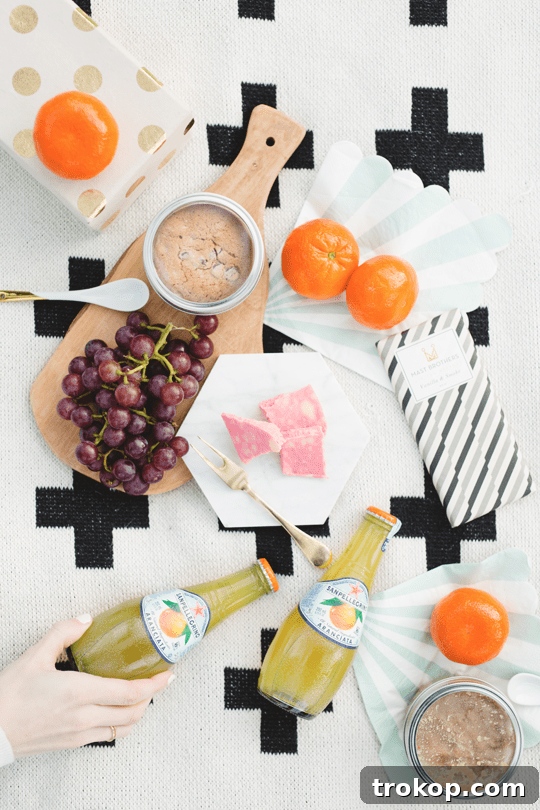 Daytime Adventures for Two 8 Beautifully arranged picnic basket with fresh fruits, cheese, chocolate, and drinks, showcasing thoughtful preparation.