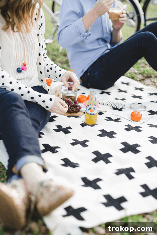 Daytime Adventures for Two 10 A vibrant picnic blanket laid out with delightful treats, creating an inviting outdoor dining scene.