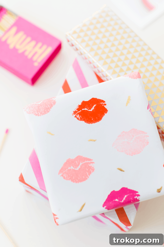 Pucker Up DIY Gift Wrap 2 DIY lip patterned gift wrap - A close-up of white paper adorned with pink and red lip stamps, showcasing a delightful and affectionate design.