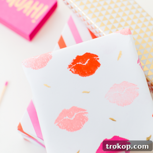DIY lip patterned gift wrap - A finished roll of custom-made gift wrap, featuring a playful lip design with gold accents.