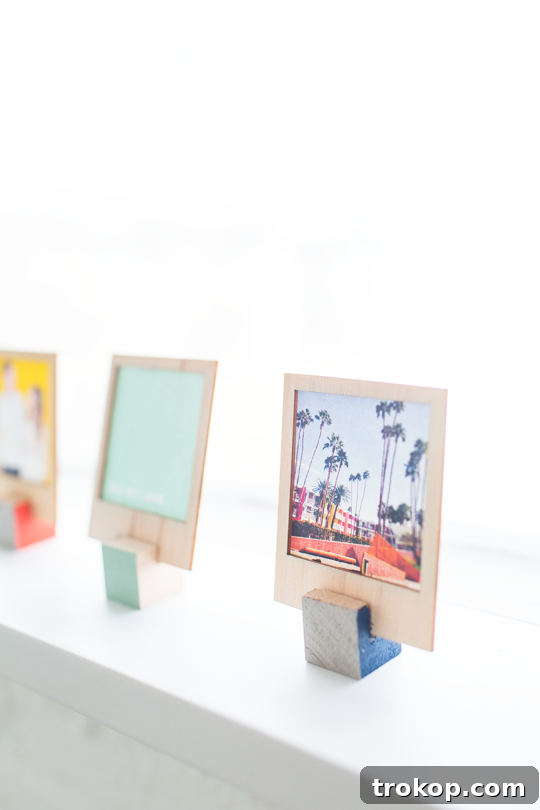 Wooden DIY Photo Display for Cherished Memories 7 Polaroids displayed in DIY wooden stands on a shelf