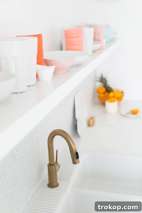 Elegant brushed brass hardware Close-up of brushed brass drawer pulls and decor in the Sugar & Cloth Studio Kitchenette