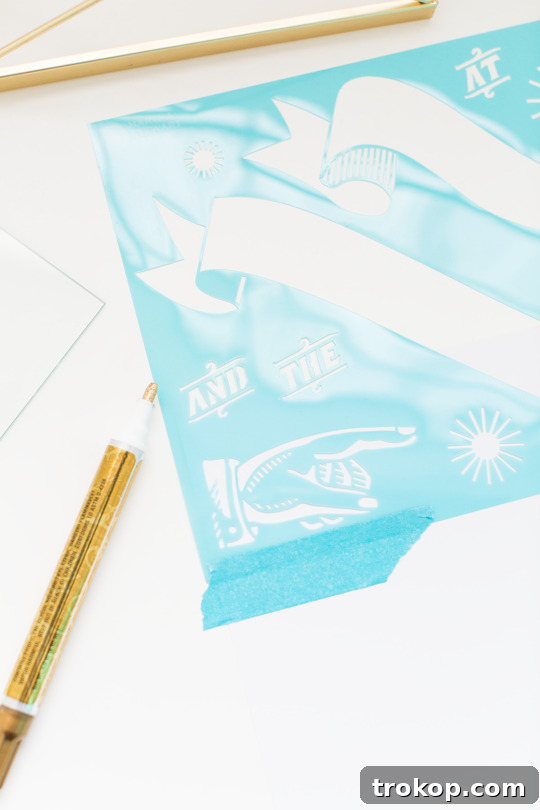 Craft Your Own Erasable Canvas 6 Close-up of a gold foiling pen being used with a stencil on white paper for the DIY dry erase board.