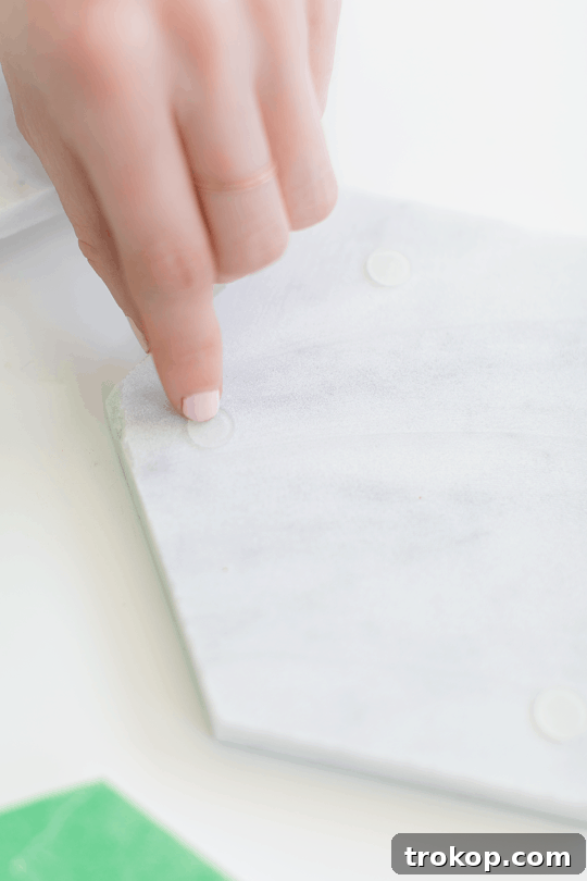 Materials laid out for DIY gilded marble hexagon serving boards, including marble tiles, adhesive bumpers, and gold leaf supplies | sugar & cloth