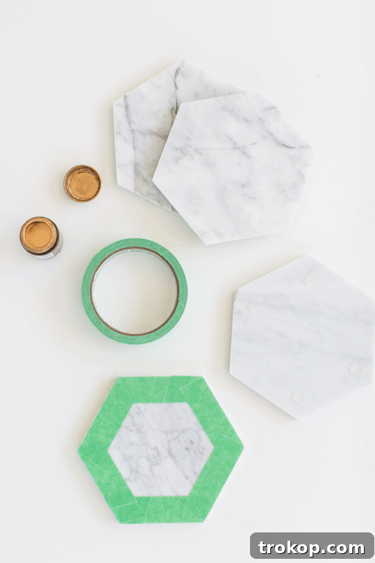 Applying clear adhesive bumpers to the unpolished backside of a DIY marble hexagon serving board | sugar & cloth