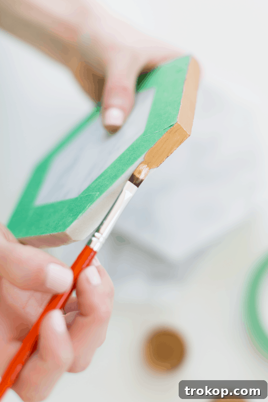Close-up of clear adhesive bumpers securely attached to the back of a DIY marble hexagon serving board | sugar & cloth