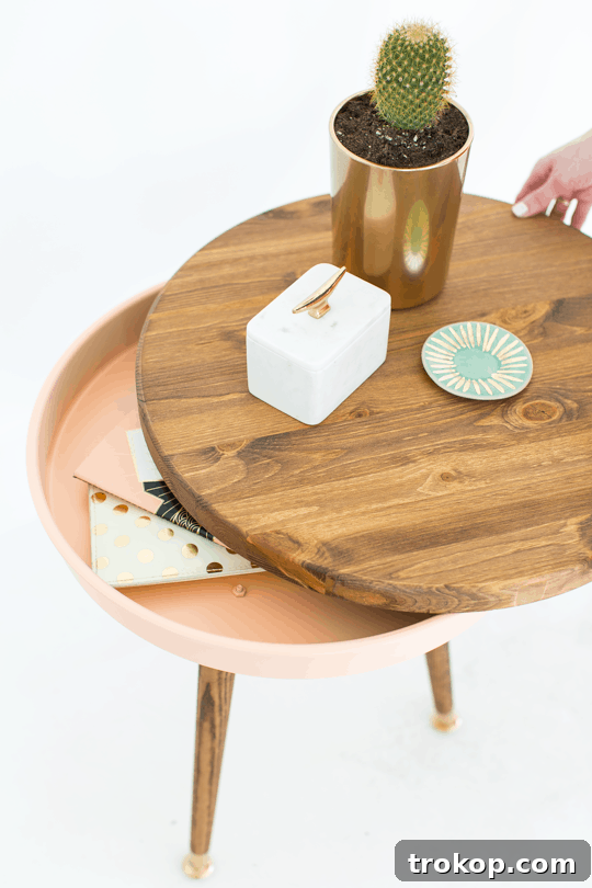 The assembled DIY Mid Century Modern Side Table with the wooden top resting on the painted cake pan storage base.