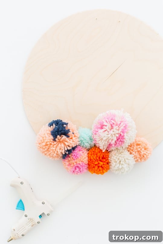 Handmade Pom Pom Wall Art 7 Step 3 -DIY Pom Pom Wall Hanging by Top Lifestyle Blogger Ashley Rose | Sugar & Cloth #DIY #pompom #wallhanging #yarn #yarnpompoms #homedecor #diydecor #colorful #make