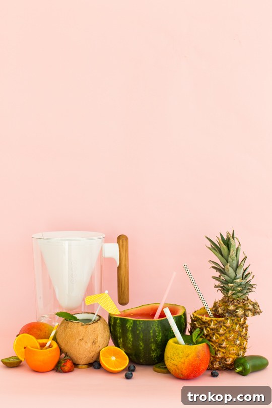 5 Refreshing Infused Water Recipes & DIY Fruit Cups 15 A hand pouring purified water from the Soma filter into a clear glass