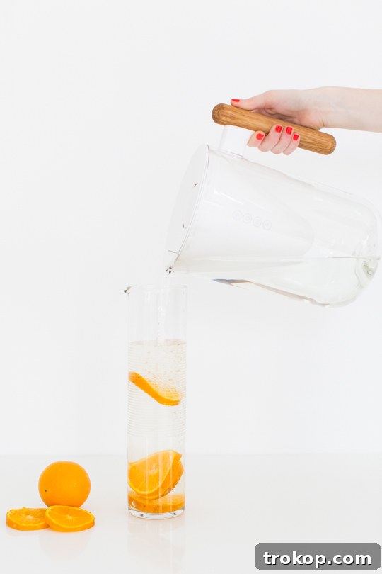 5 Refreshing Infused Water Recipes & DIY Fruit Cups 5 Assortment of fresh fruits and herbs laid out for preparing infused water