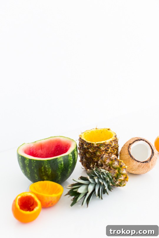 5 Refreshing Infused Water Recipes & DIY Fruit Cups 6 A refreshing glass of infused water served creatively in a hollowed-out pineapple cup