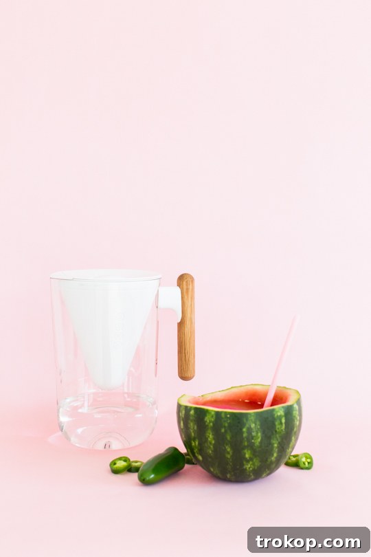 5 Refreshing Infused Water Recipes & DIY Fruit Cups 7 Close-up of spicy Jalapeño Watermelon Infused Water served in a watermelon rind cup