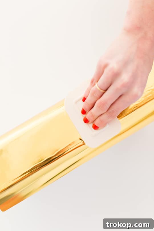 Faux Brass Drawer Facelift 6 Applying gold foil with a squeegee
