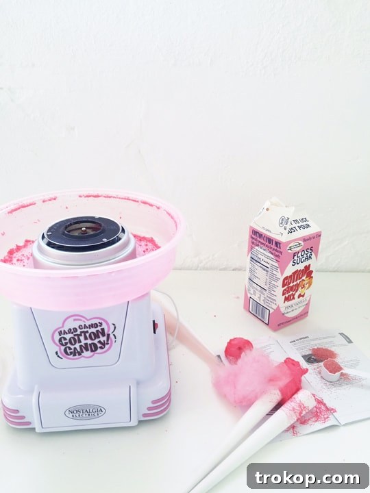 The cotton candy maker in action, producing fluffy clouds of sugary goodness