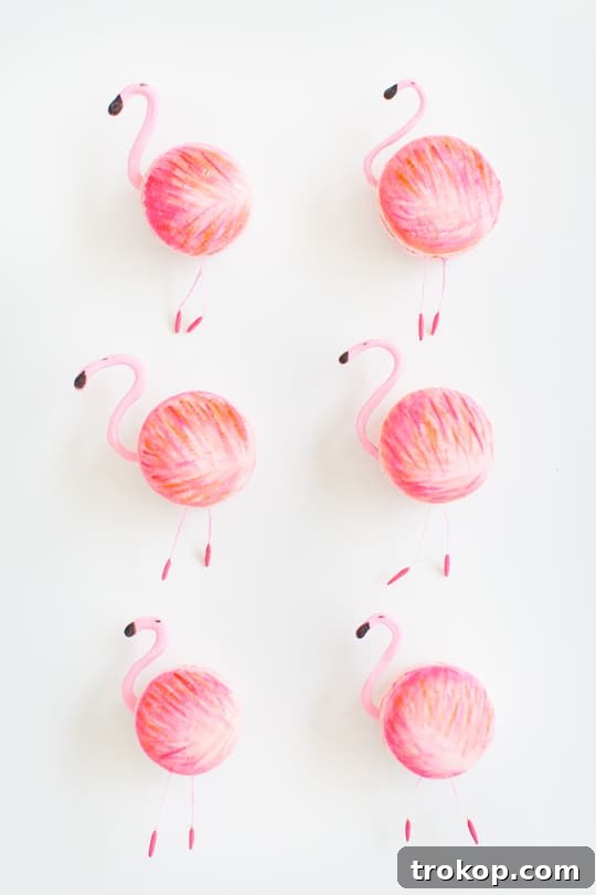 Close-up of pink macaron shells and delicate fondant stamens, ready for assembly