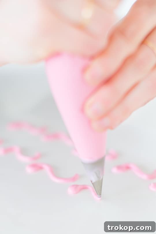 Detail shot of delicate chocolate 'S' shapes forming flamingo heads, cooling on wax paper