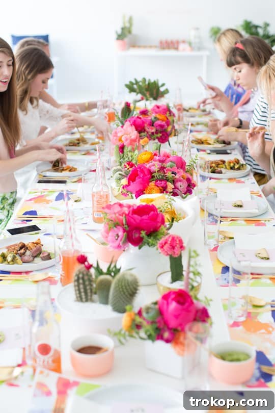 A beautifully decorated cactus brunch table with food, drinks, and floral arrangements