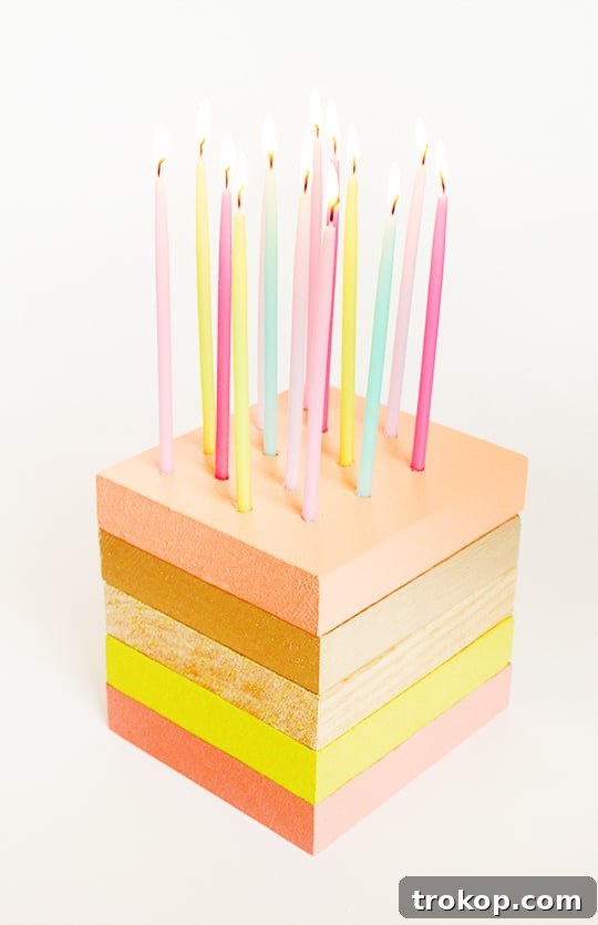 DIY wooden birthday cake with candles lit, creating a warm ambiance