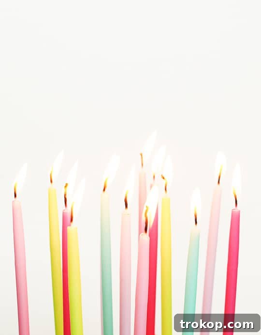 Materials laid out for DIY wooden birthday cake project: wood boards, paint, candles, drill