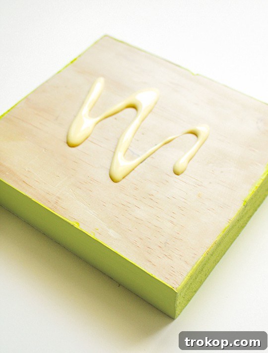 Drilling holes into the top wooden board for candles
