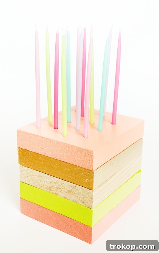 Completed DIY wooden birthday cake with candles lit, ready for celebration