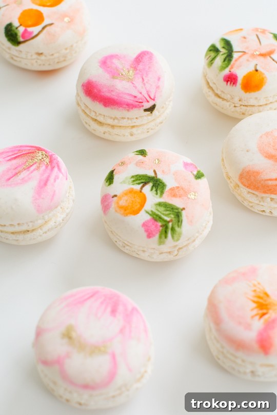 Blossom Bites: Crafting Hand-Painted Floral Macarons 5 Macarons artfully decorated with flowers, ready for a special occasion.