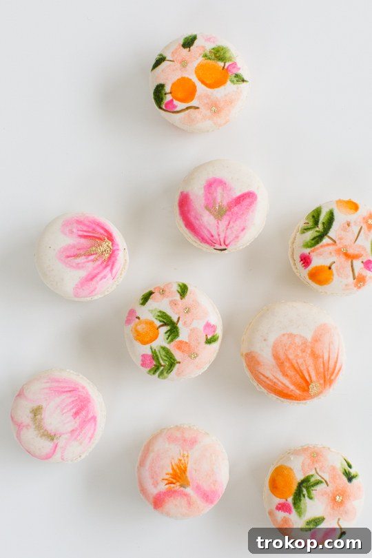 Blossom Bites: Crafting Hand-Painted Floral Macarons 8 Assorted floral macarons in a box, ready for gifting or serving at a party.