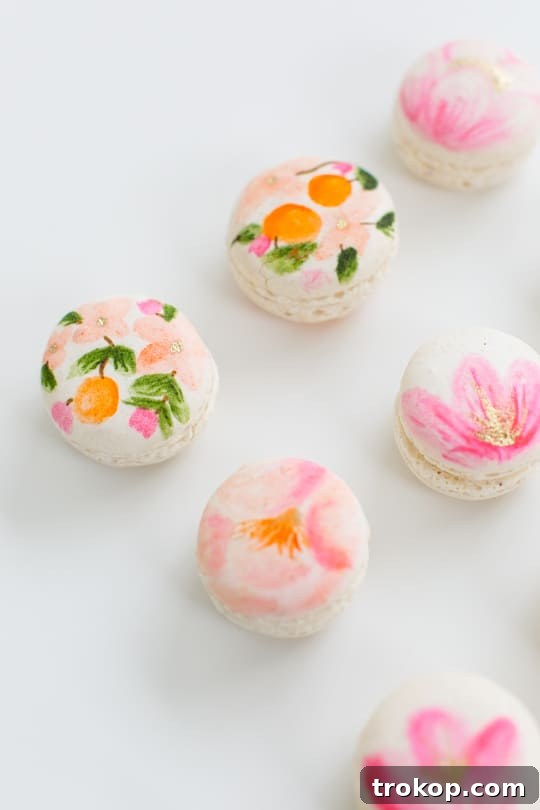 Blossom Bites: Crafting Hand-Painted Floral Macarons 10 Hand-painted macarons with vibrant floral designs, perfect for spring.