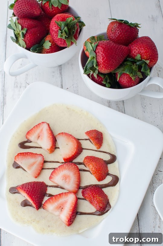 Strawberry Almond Crepes with Decadent Chocolate Drizzle 5 Finished strawberry almond crepes with chocolate sauce, ready to be served