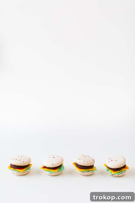 An overhead view of the complete miniature feast: macaron cheeseburgers, cookie fries, and a charming mini milkshake.