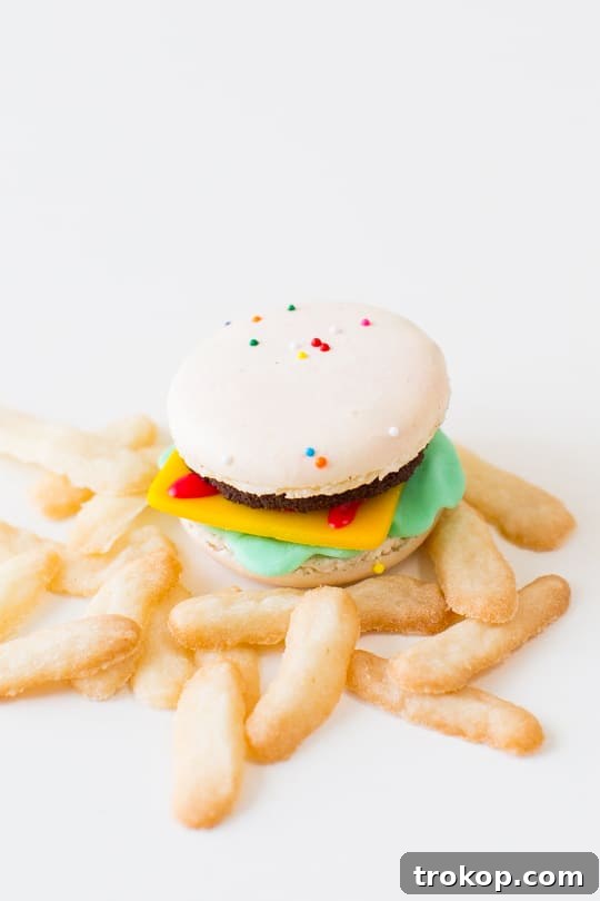 Detailed close-up of a single mini macaron cheeseburger, showcasing the textures and colorful layers, ready for enjoyment.