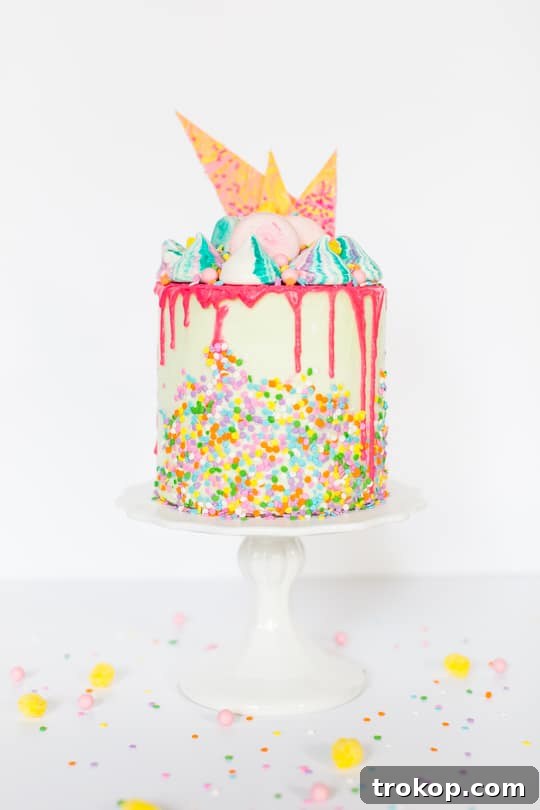A whimsical Unicorn Strawberry Cake, vibrant with colorful sprinkles and a creamy frosting.