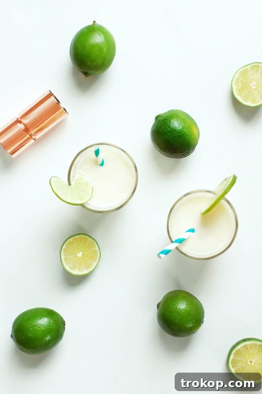 Blended Brazilian Limeade Cocktail - The creamy, green mixture in a blender, ready to be served over ice.