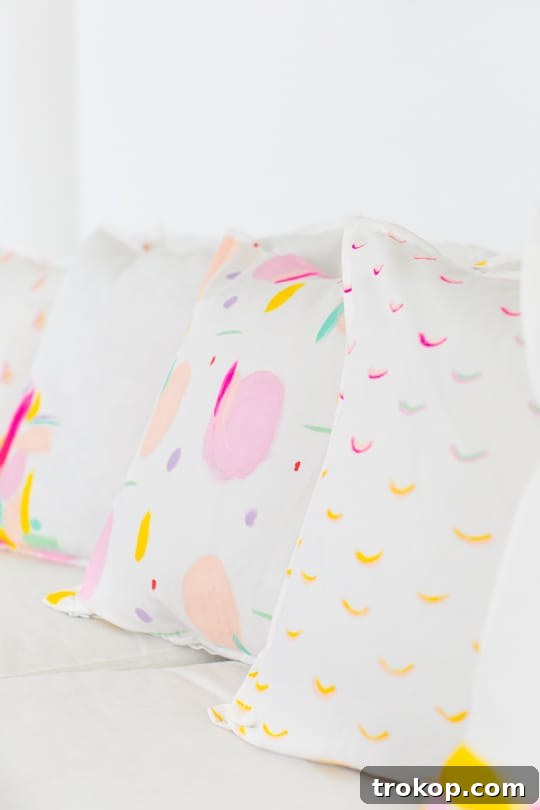 Modern living space featuring custom DIY pattern throw pillows and a neon sign