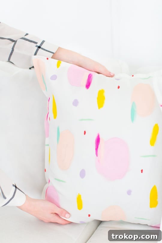 Assorted DIY pattern throw pillows in a modern living room setting
