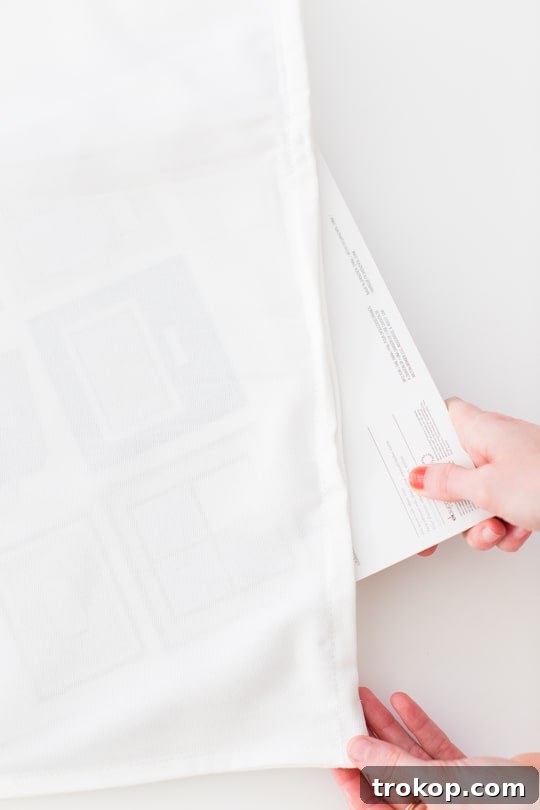 Placing newspaper inside a white pillow cover before painting