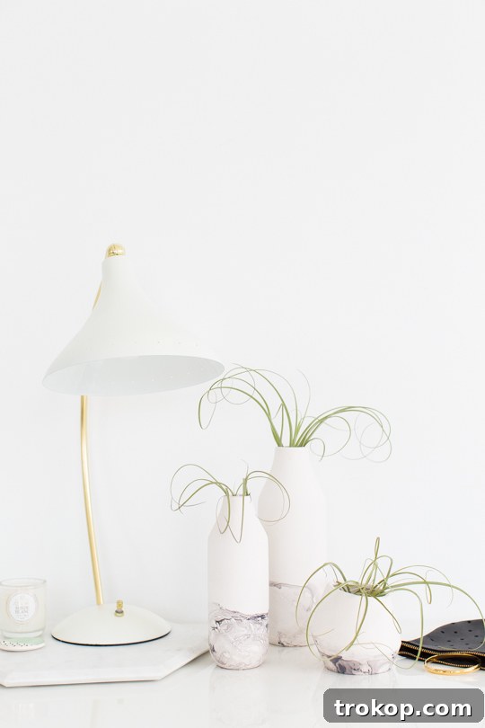 Elegant DIY marble dipped vase showcasing the beautiful swirled effect created with nail polish.